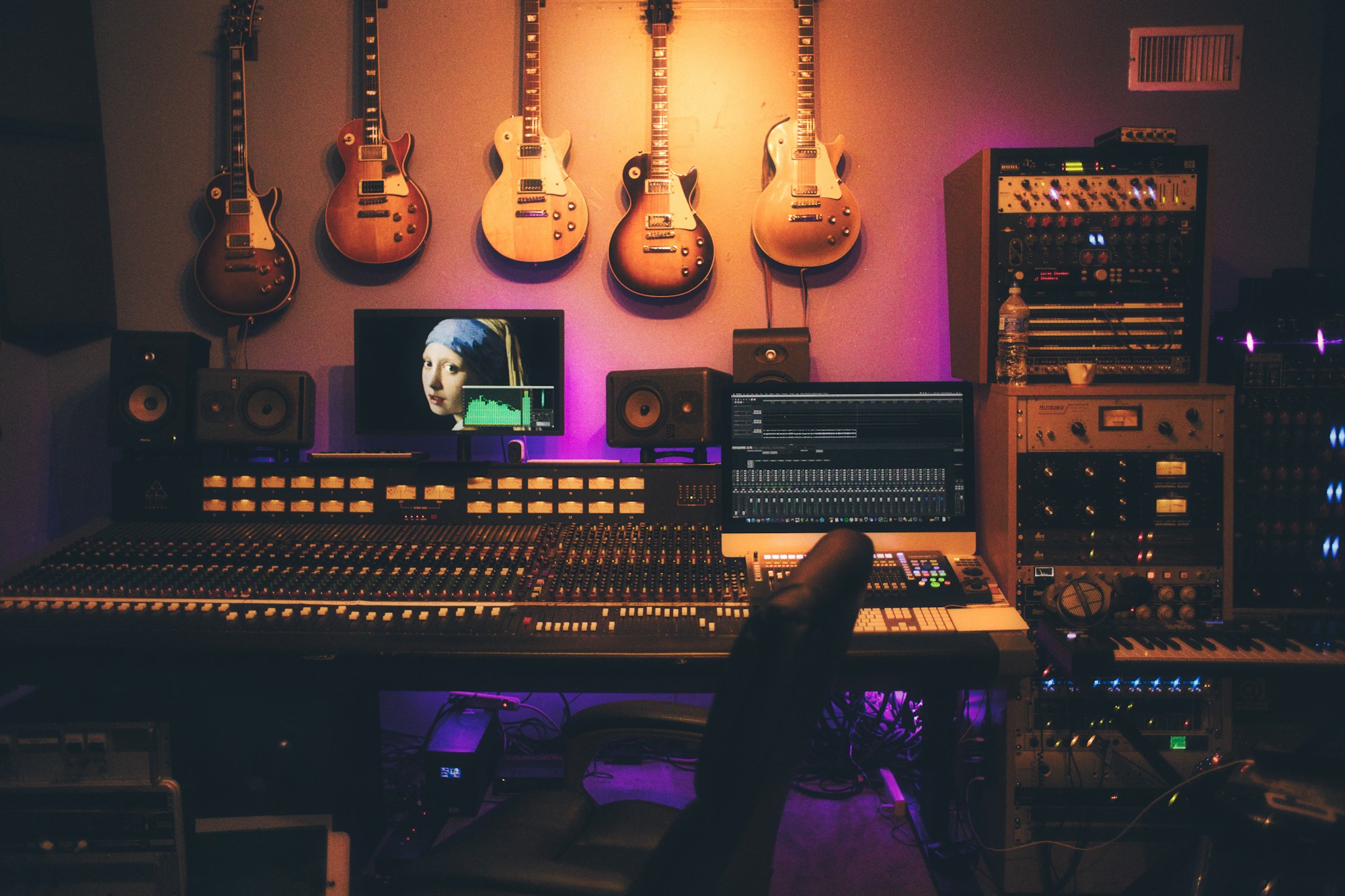 A recording studio lit in warm amber tones